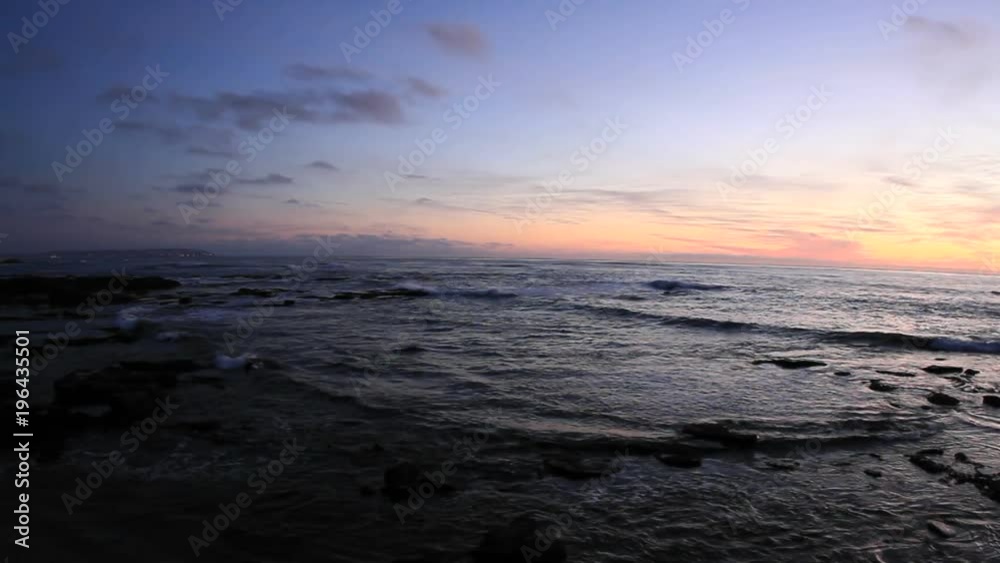 Waves roll on to a beach just after sunset. Waves roll on to a beach just after sunset.