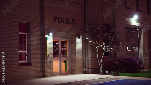 Exterior establishing shot of a small police station at night. photo