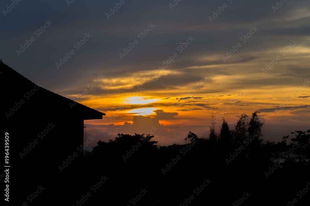 Silhouette home and tree with beautiful sunset