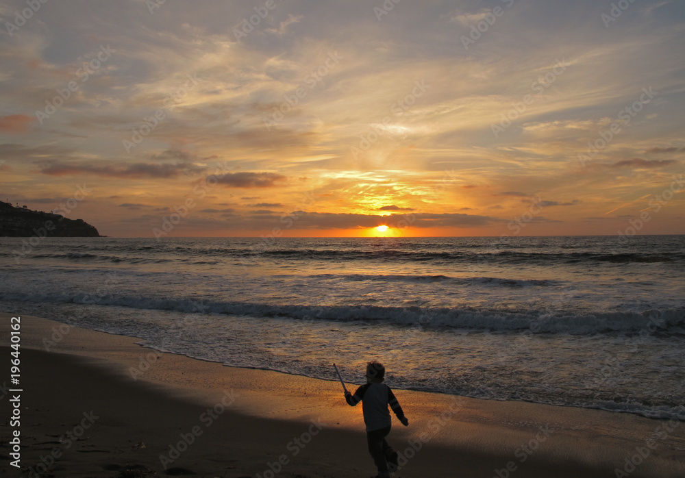 Toddler Playing on the Beach Silhouette at Torrance Beach During Sunset, California