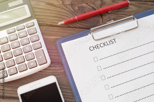 checklist, smartphone and calculator. planning, business finance purpose