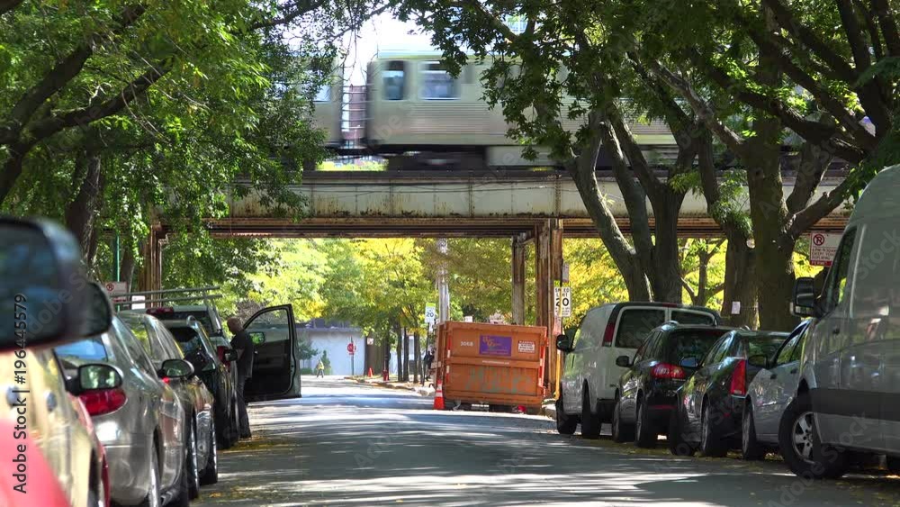 Establishing shot of a neighborhood in downtown Chicago wil El train passing.