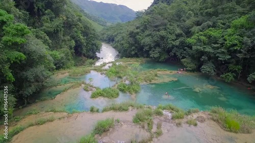 An aerial over remarkable waterfalls and green polls on the Semuc Champey river in Guatemala. photo