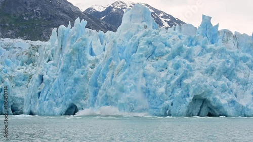Slow motion of the Dawes glacier in Alaska calving suggests global warming.