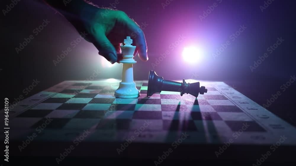 Slider shot. Chess board game concept of business ideas and competition and strategy ideas concept. Chess figures on a dark background with smoke and fog. Selective focus