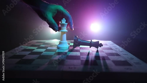 Slider shot. Chess board game concept of business ideas and competition and strategy ideas concept. Chess figures on a dark background with smoke and fog. Selective focus