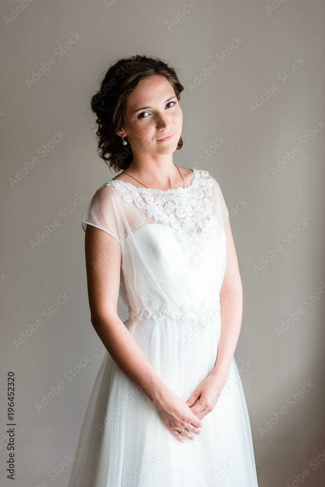 Portrait of young bride in a traditional white wedding dress Portrait of young bride in a traditional white wedding dress