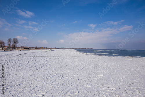 snow covered beach and sea