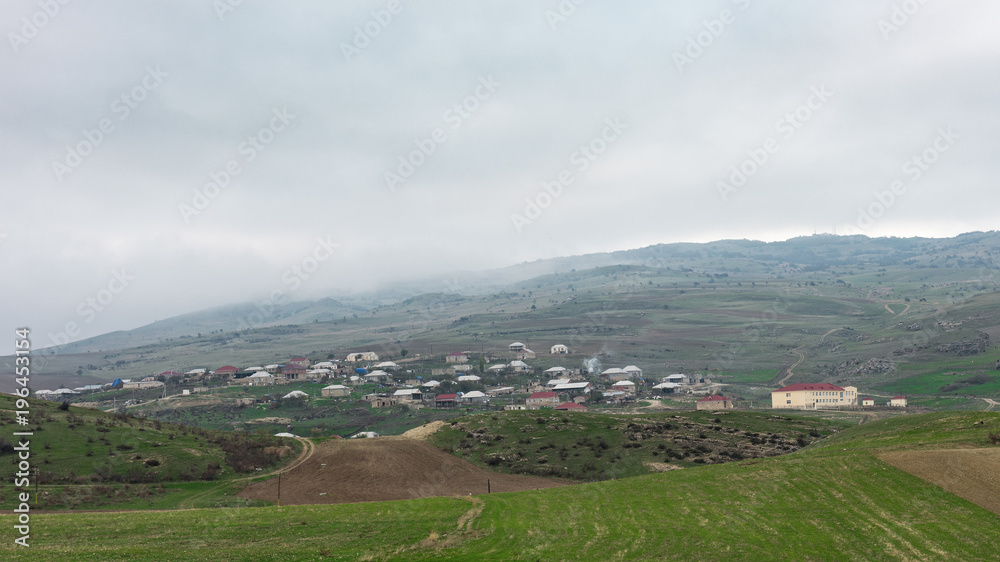 A small village on a mountain slope A small village on a mountain slope