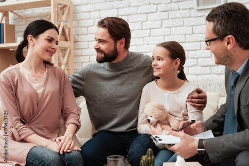 Happy family of three talking with psychologist. Family psychotherapy concept.