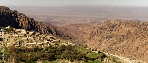Bild auf Leinwand The village of Dana on the edge of the Dana Reserve, a deep valley cut in the so