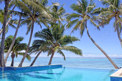 Fototapeta Naklejka Na Ścianę i Meble -  Swimming pool in a tropical resort on a bright clear day