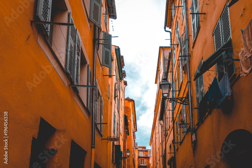 ancient orange houses in a alley at nice