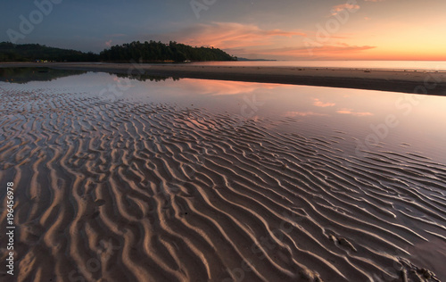 Long expose seascape with stunning sunset colors and natural sand pattern. 