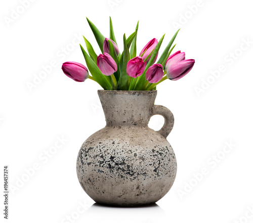 Lilac tulips in a concrete vase on a white background