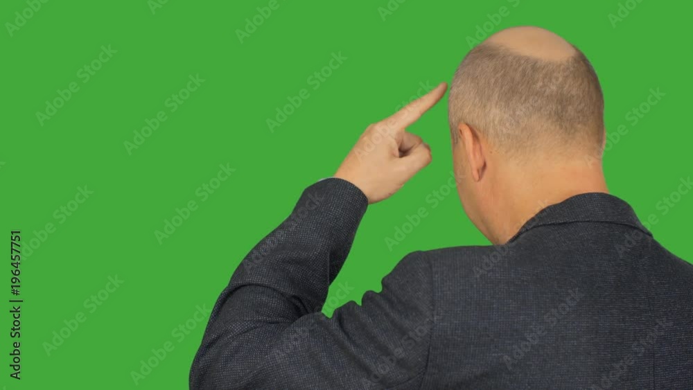 Thinking man knocking finger on forehead back view on green background. Alpha channel, keyed green screen. Thinking man knocking finger on forehead back view on green background. Alpha channel, keyed green screen.