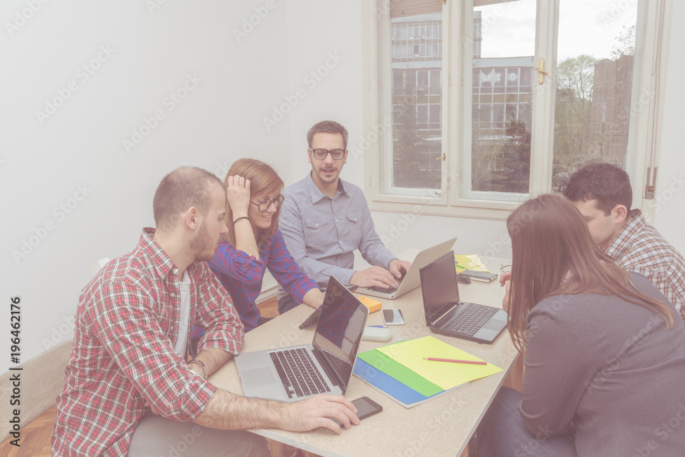 Real and ordinary young people in the office being creative and resolving business plans.