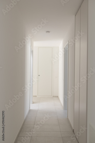 White empty corridor with many closets