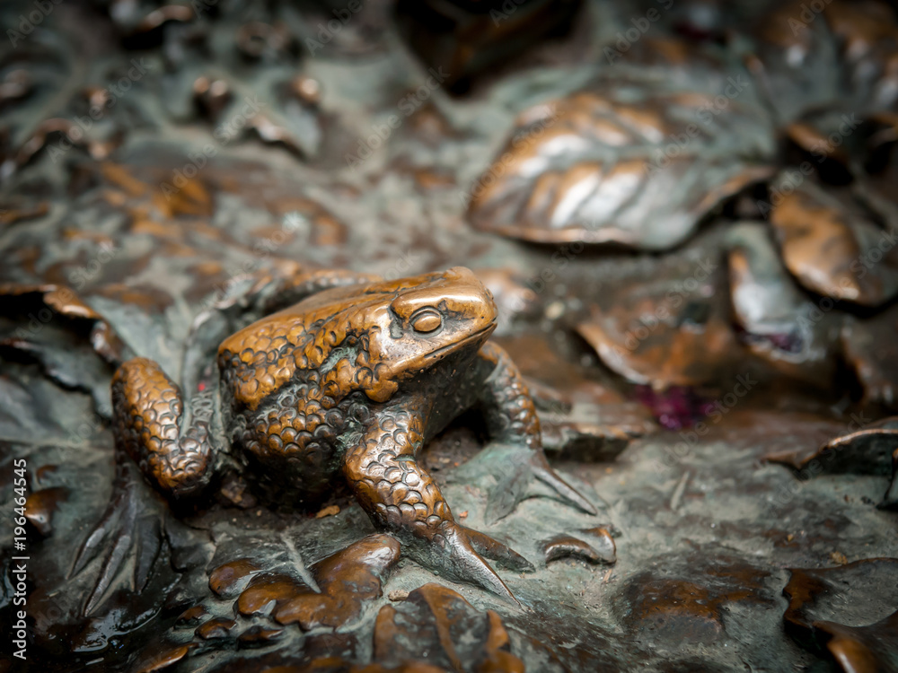 Toad made of bronze, detail of a monument
