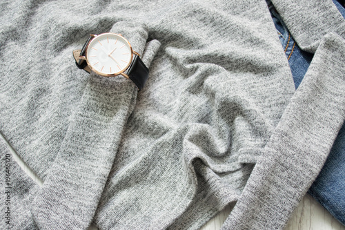 Watch on a gray sweater. Close-up. Details. Fashionable concept photo