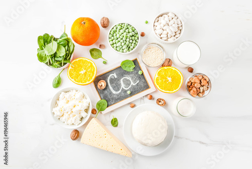 Healthy food concept. Set of food rich in calcium - dairy and vegan Ca products, white marble background top view photo