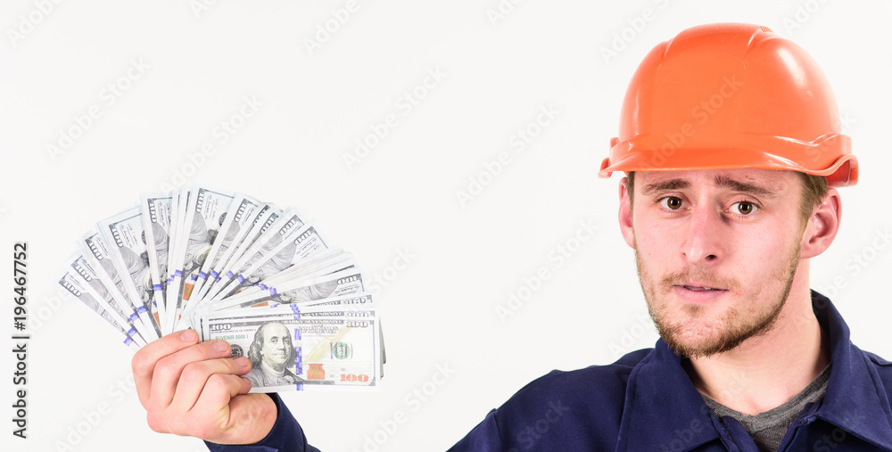 Builder earn money, repairman holds cash, banknotes in hand. Builder earn money, repairman holds cash, banknotes in hand.