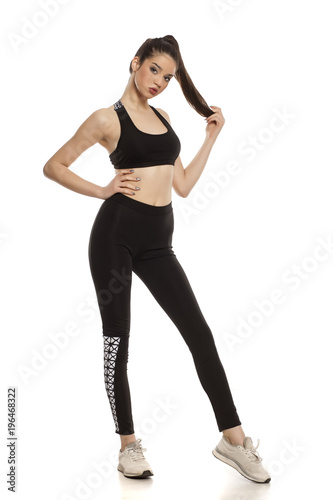 young woman in sportswear on white background