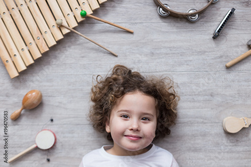 beautiful little girl surrounded by several instruments