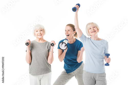 Sportswomen with dumbbells and coach with megaphone isolated on white