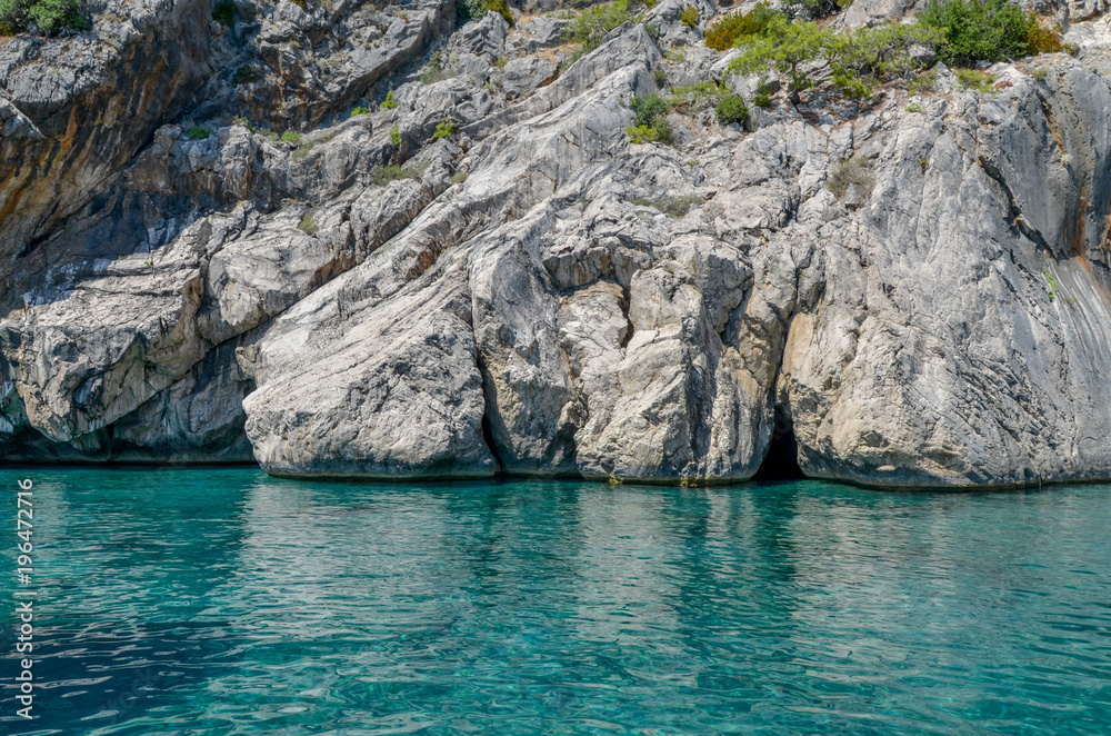 secret cave entrance and clear sea green water near the cliffs of Turkish Mediterranean coast Cirali, Antalya province