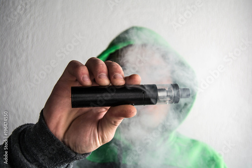 the guy in the hood is spinning an electronic cigarette