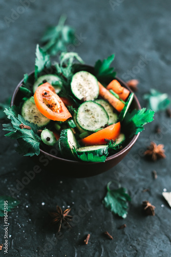 Fresh salad with vegetables on a black matte background. The concept of a healthy diet photo