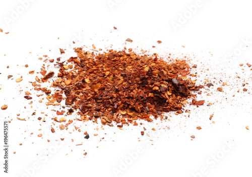 Crushed red cayenne pepper, dried chili flakes and seeds pile isolated on white background