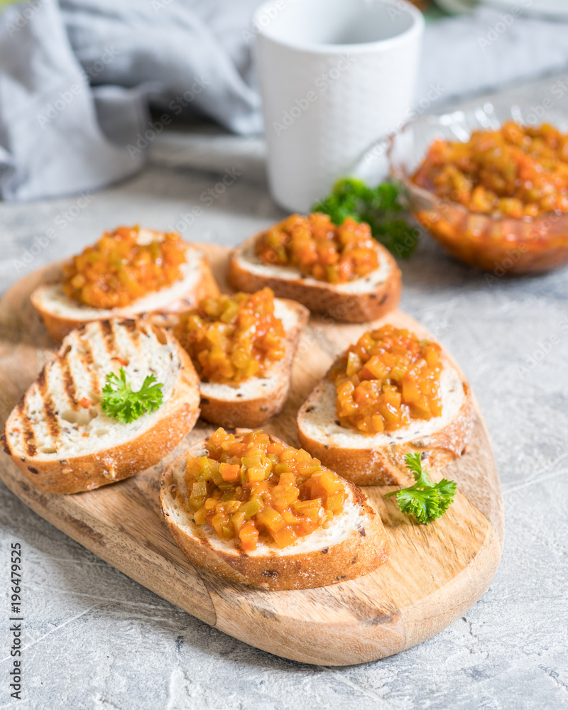Toasted bread with vegetable caviar, made of squash, pumpkin, tomato, carrot Toasted bread with vegetable caviar, made of squash, pumpkin, tomato, carrot
