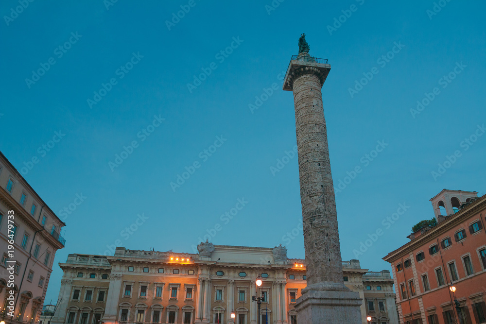 Ancient Roman Column of Marcus Aurelius in Piazza Colonna in evening Rome