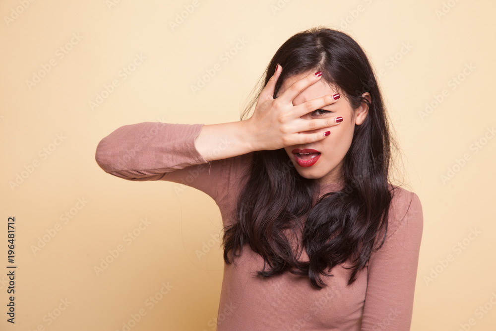 Beautiful young Asian woman peeking through fingers. Beautiful young Asian woman peeking through fingers.