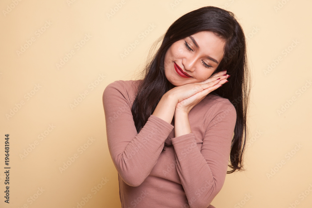 Beautiful young Asian woman with sleeping gesture. Beautiful young Asian woman with sleeping gesture.