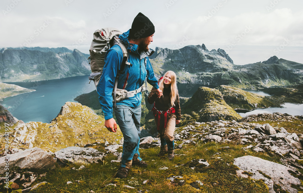 Couple backpackers hiking in Norway mountains love and travel holding hands family together Lifestyle concept vacations outdoor