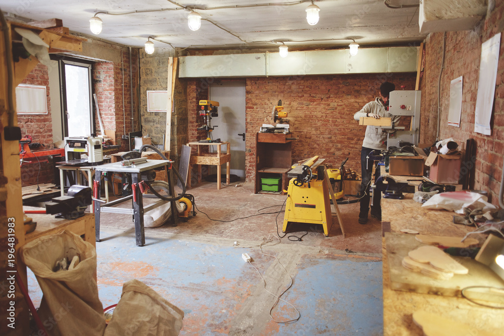 The young carpenter works in a workshop The young carpenter works in a workshop