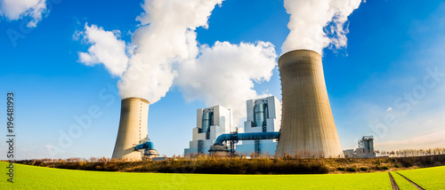 Power plant with two smoking cooling towers photo