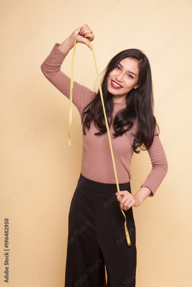 Young Asian woman with measuring tape.
