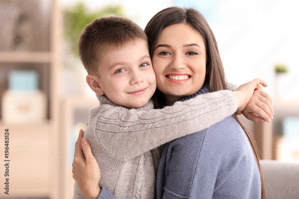 Young woman with little boy indoors. Child adoption Young woman with little boy indoors. Child adoption