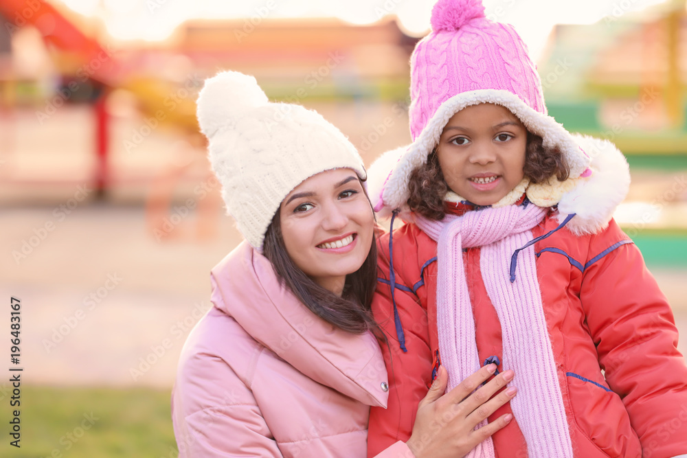 Young woman with little African-American girl outdoors. Child adoption Young woman with little African-American girl outdoors. Child adoption