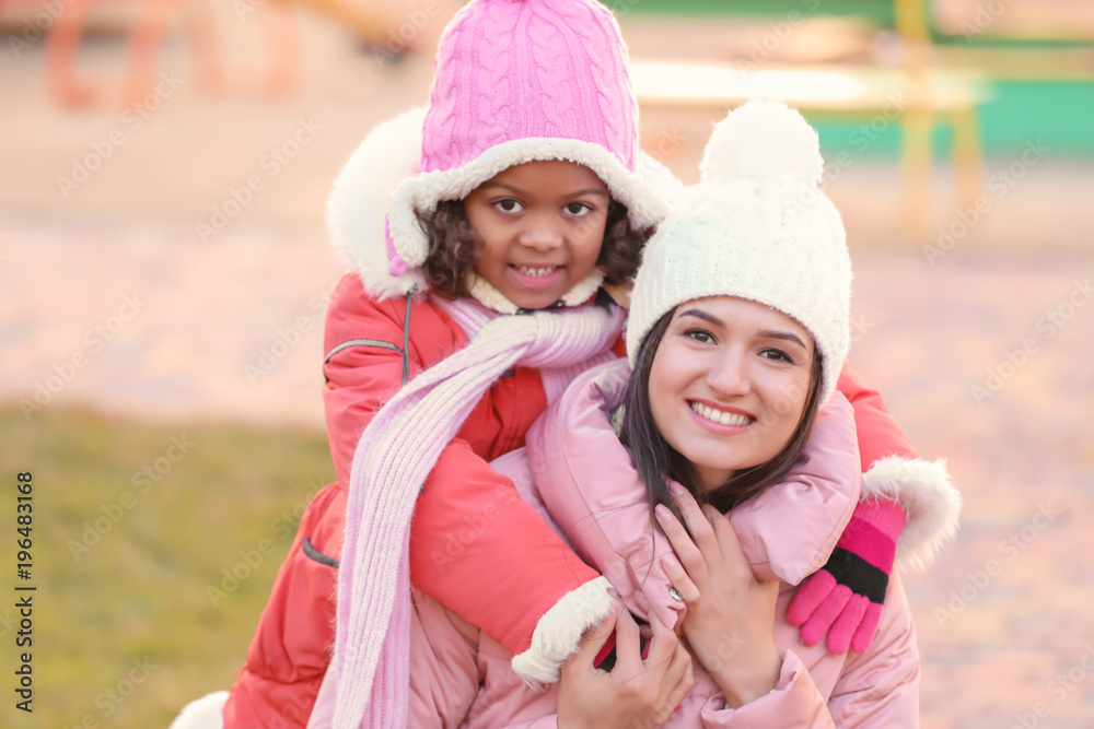 Young woman with little African-American girl outdoors. Child adoption Young woman with little African-American girl outdoors. Child adoption