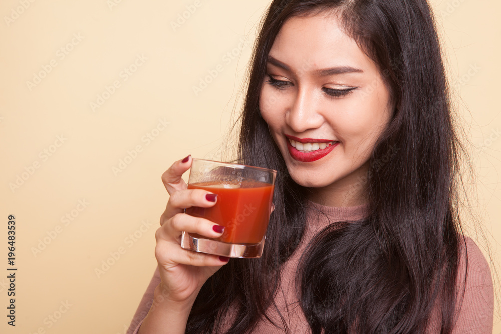 Asian woman with a clock drink orange juice. Asian woman with a clock drink orange juice.