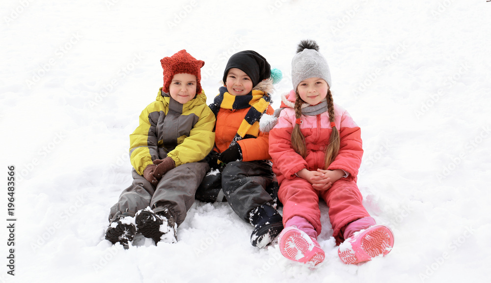 Happy children in snowy park on winter vacation Happy children in snowy park on winter vacation
