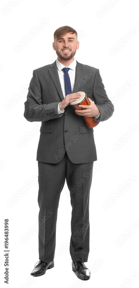 Young businessman holding little djembe on white background Young businessman holding little djembe on white background