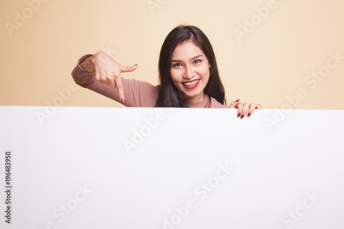 Young Asian woman with blank sign.