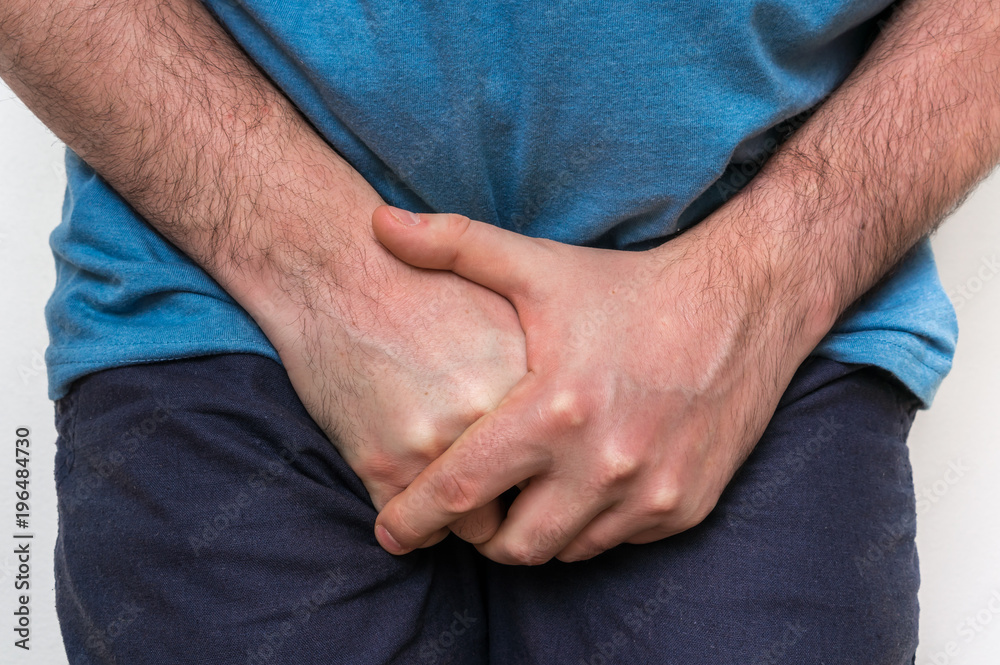 Man with incontinence problem is holding his crotch Man with incontinence problem is holding his crotch