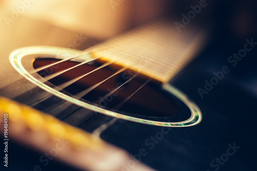 Acoustic guitar with shallow depth of field, sensitive focus photo